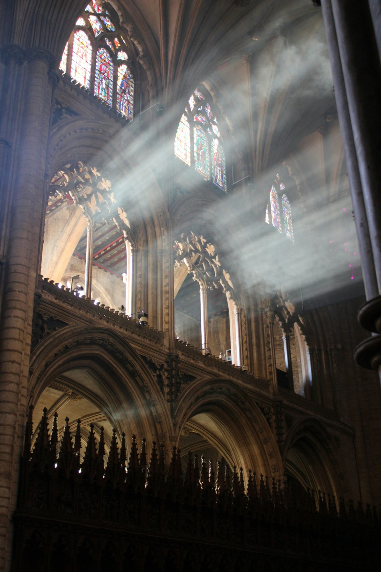 Light streaming through stained glass windows into a cathedral