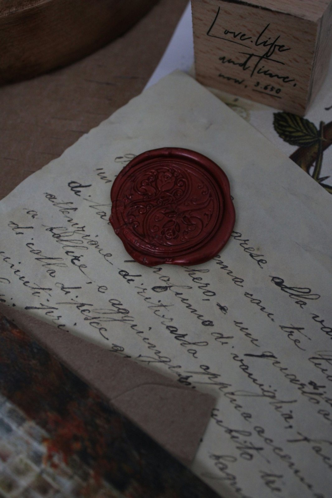A red wax seal on a handwritten letter